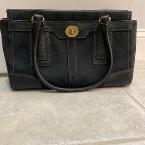 Used black coach handle bag. Inside zipper. Inside with 2 pockets.